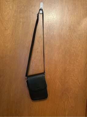 NEW Never used. Genuine leather black crossbody, rfid blocking, adjustable strap